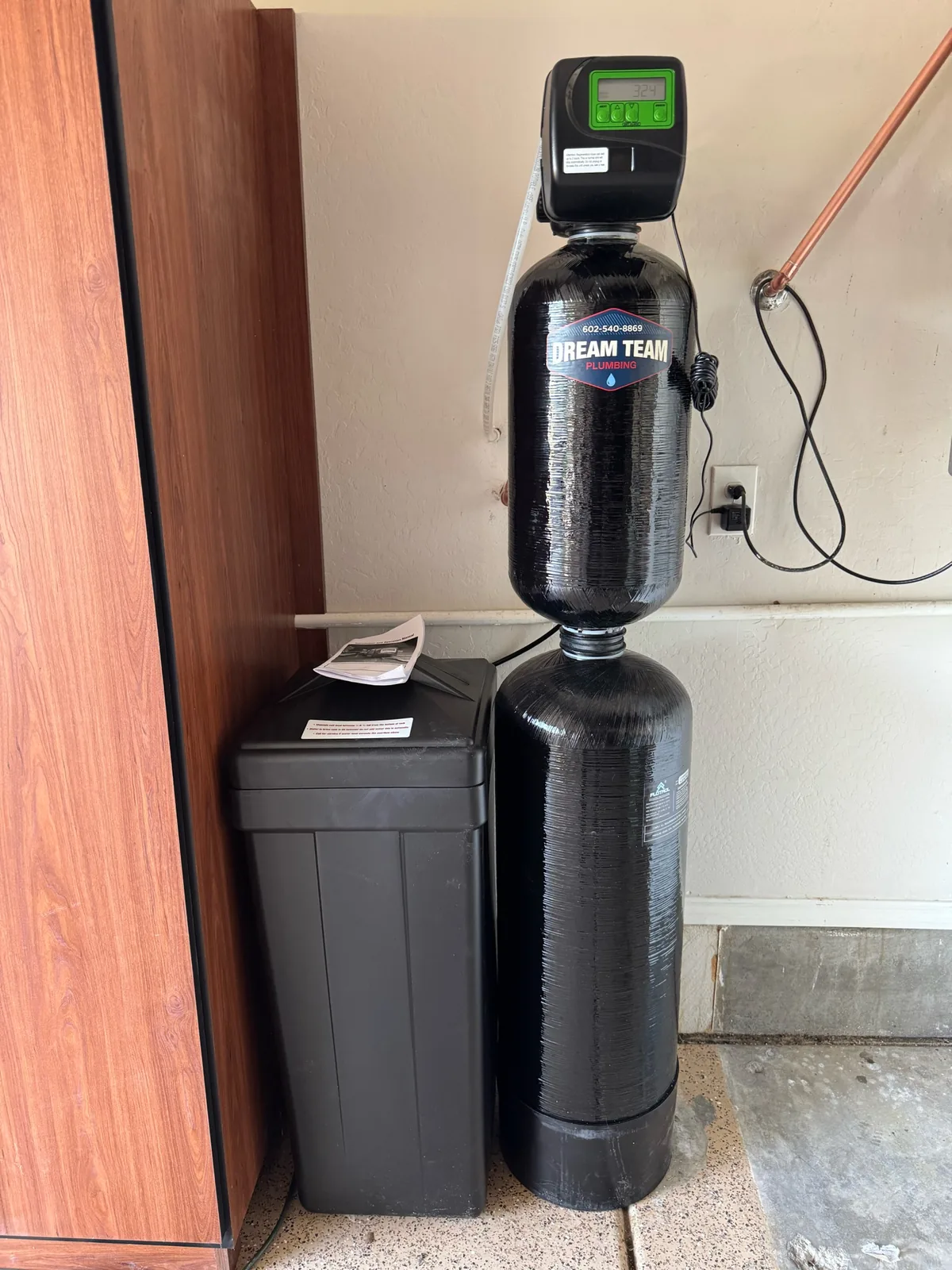 Actual Dream Team Plumbing whole-home water softener equipment installed in an East Valley garage